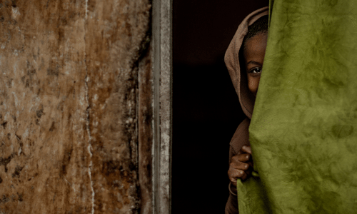 child-behind-curtain-in-congo
